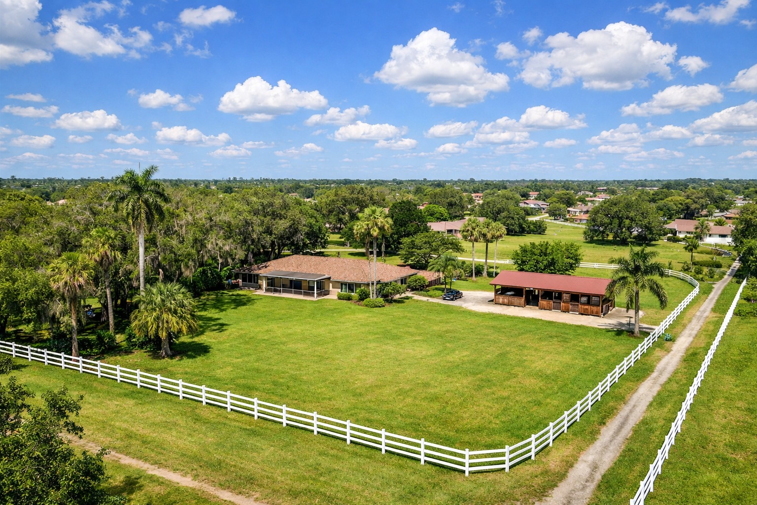 Davie Florida acreage property with horse stables white wooden ranch fence and large lot under live oak canopy where buyers find no HOA properties 2026