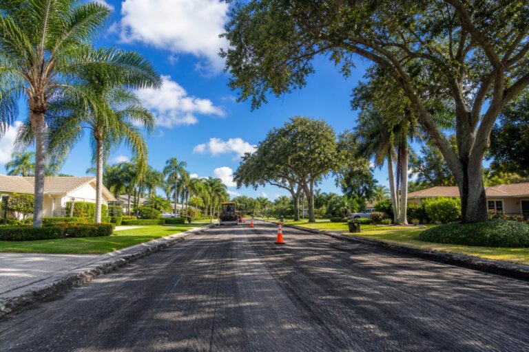 Davie Florida residential roadway with single lane traffic and paving operations representing the SW 82nd Avenue roadway reclamation project between Griffin Road and Stirling Road for 2026