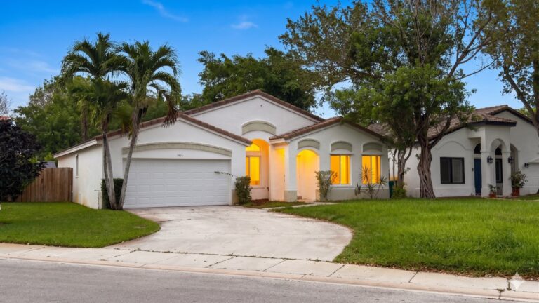 Single story pool home with paver driveway and tropical landscaping in Harmony Lakes Davie Florida showing what a $650,000 four bedroom home looks like in the 33324 zip code in 2026
