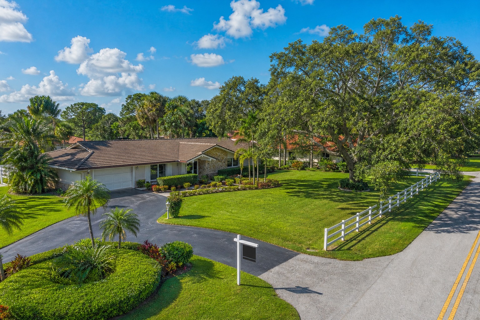 Davie Florida ranch style home with For Sale sign and white equestrian fencing where sellers pay documentary stamp tax at closing 2026