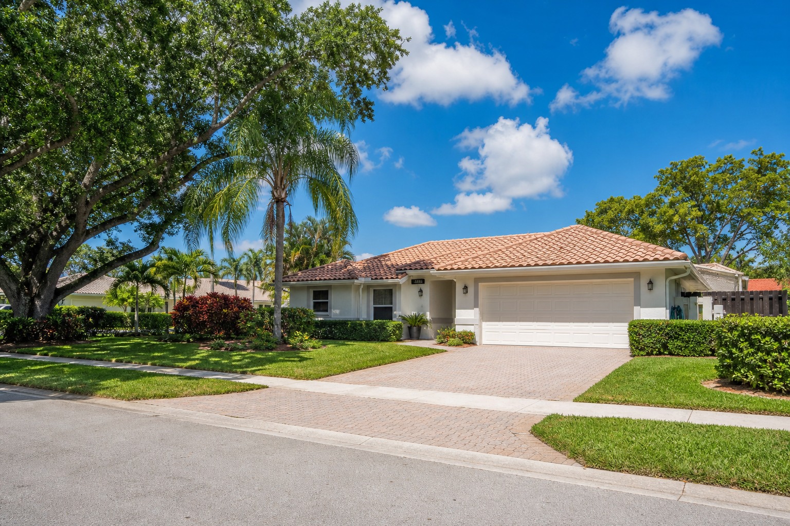Davie Florida single family home that recently sold, with a tile roof, palm trees, and a paver driveway, representing a seller calculating net proceeds in 2026