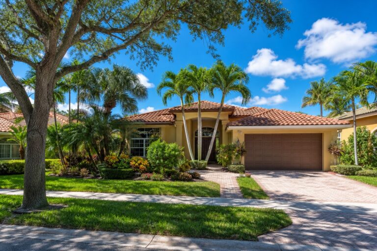 Davie Florida single family home exterior representing a buyer deciding whether to hire a buyer agent in 2026, with palm trees and a tile roof