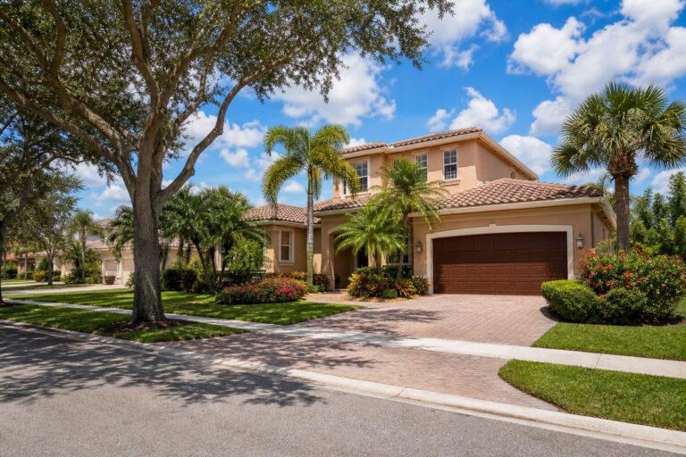 Hawkes Bluff Davie Florida single family home with a tile roof, two car garage, palm trees, and a paved driveway on a quiet suburban street in 2026