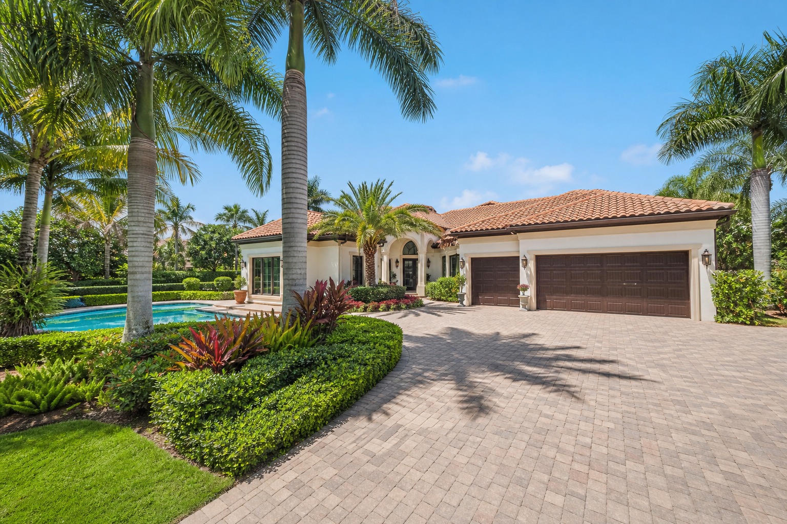Representative single story pool home with a three car garage and mature landscaping in The Islands of Weston Florida, illustrating the style of 1640 Island Way