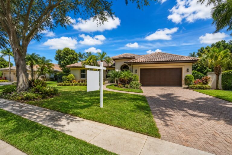 Davie Florida single family homestead home with a for sale sign in the front yard, palm trees, and a tile roof, representing Save Our Homes portability for sellers in 2026