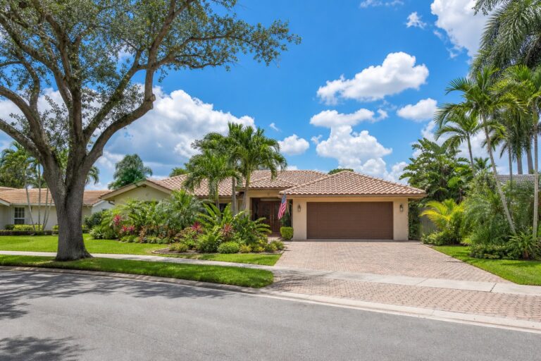Davie Florida single family home with an American flag by the front entry, palm trees, and a tile roof, representing a veteran buying with a VA loan in 2026
