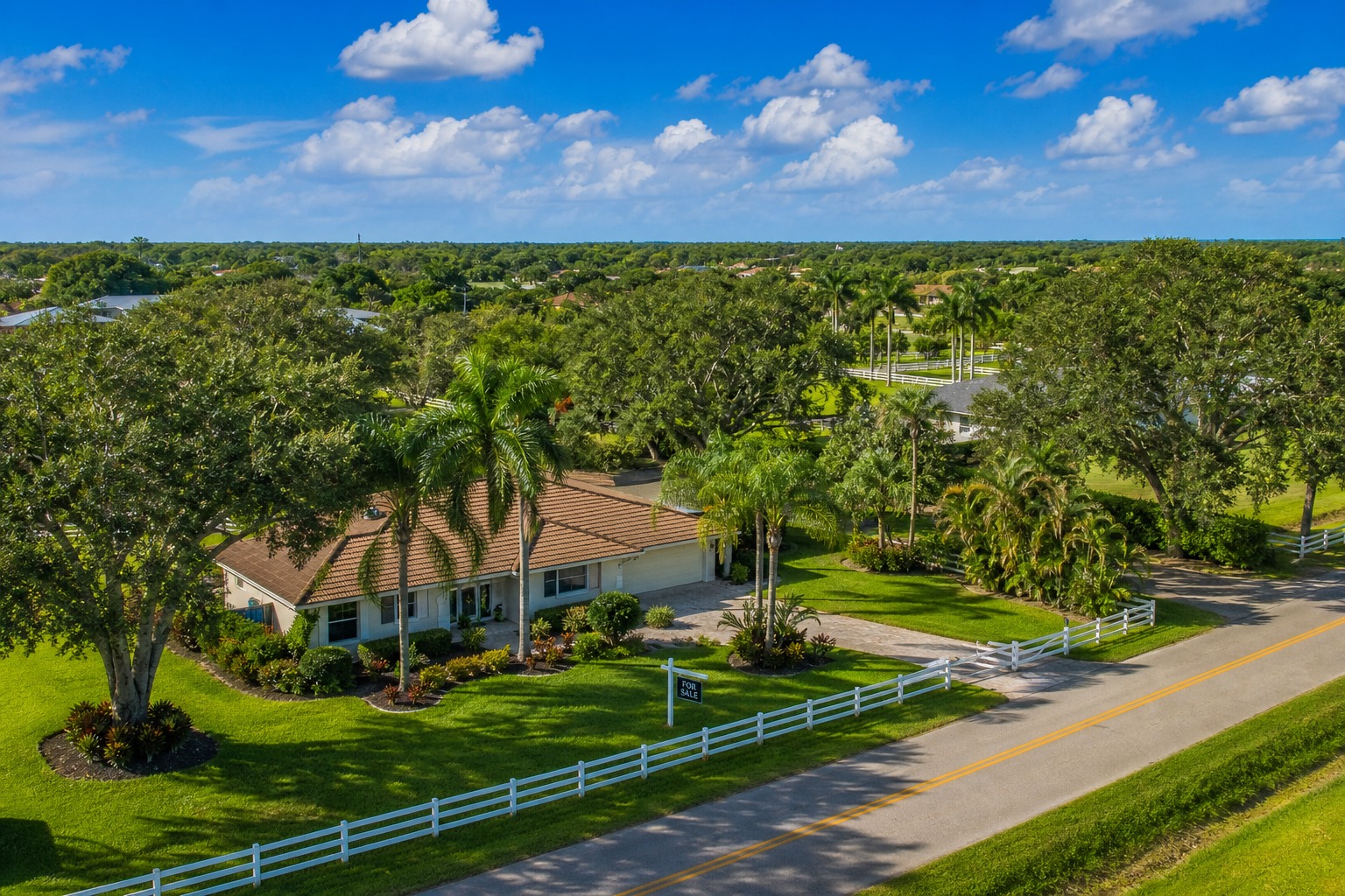 Davie Florida residential street with ranch style home and For Sale sign representing the transaction broker versus single agent representation choice 2026