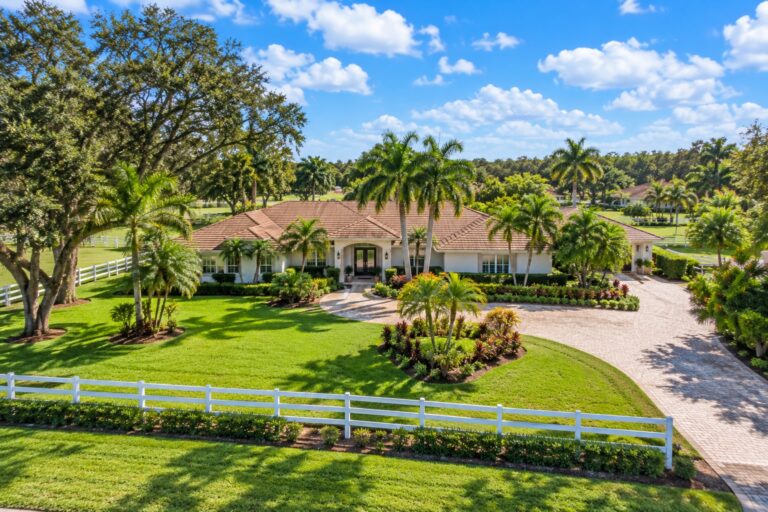 Davie Florida ranch style home with a tile roof, white equestrian fencing and palm trees, representing property tax exemptions beyond homestead for Davie owners