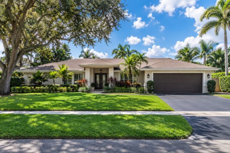 Davie Florida single story ranch style home with a paved driveway, palm trees and a mature oak tree, relevant to Florida's new rental application fraud law starting October 1 2026